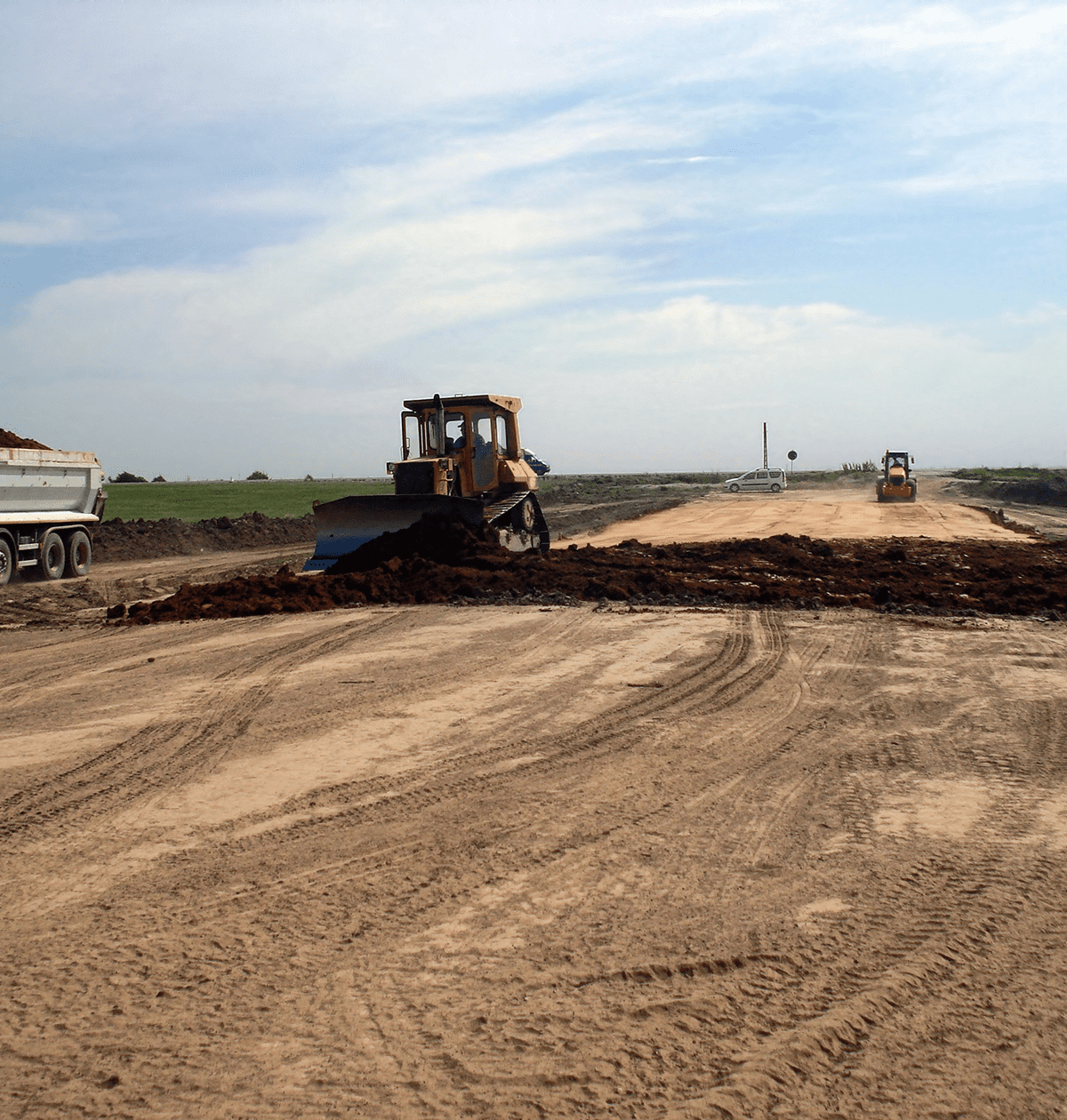 Earthmoving equipment on a dirt road