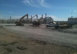 Excavators and gravel in open area